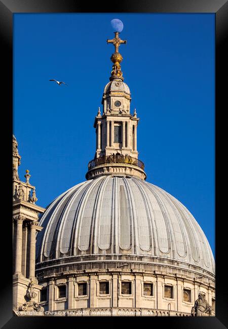 The Moon Perched on St. Pauls Catehdral Framed Print by Chris Dorney