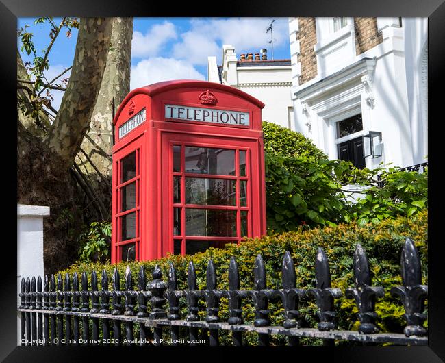 Red Telephone Box in London Framed Print by Chris Dorney