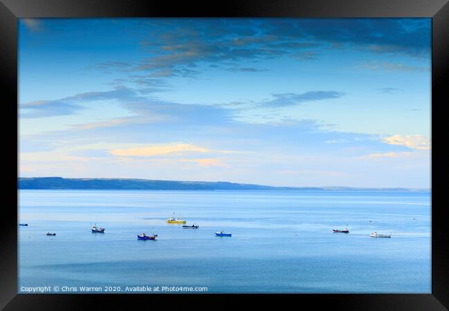 Boats moored in the bay Framed Print by Chris Warren