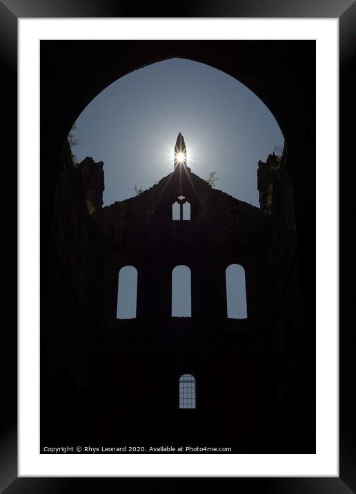 Sun flares through opening in the peak of a ruined wall of kirkstall abbey Framed Mounted Print by Rhys Leonard