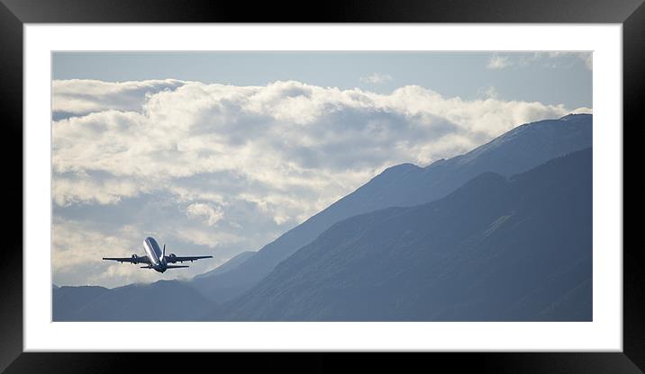 Airplane taking off over the alpine mountains Framed Mounted Print by Ian Middleton