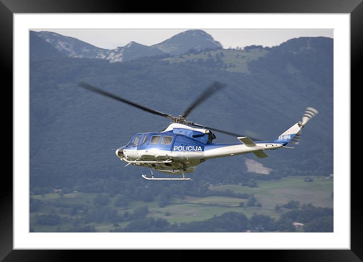 Police helicopter patrolling Framed Mounted Print by Ian Middleton