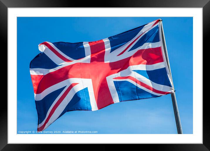 Union Flag over a Clear Blue Sky Framed Mounted Print by Chris Dorney