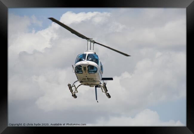 helicopter under cumulous clouds Framed Print by chris hyde