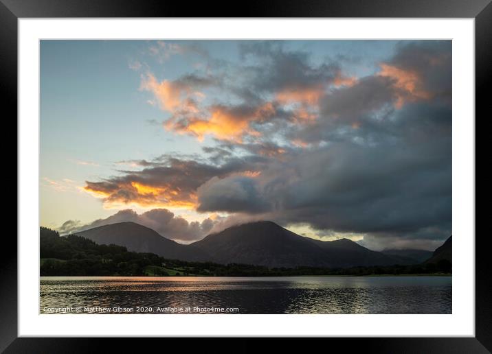 Beautiful sunrise landscape image looking across Loweswater in the Lake District towards Low Fell and Grasmere with vibrant sunrise sky breaking on the mountain peaks Framed Mounted Print by Matthew Gibson