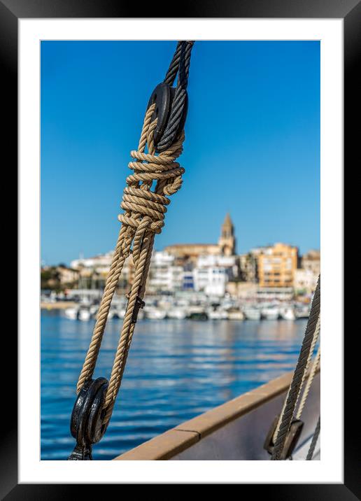 Small Spanish town in Costa Brava, Palamos.Foreground a sail boat rigging. Framed Mounted Print by Arpad Radoczy