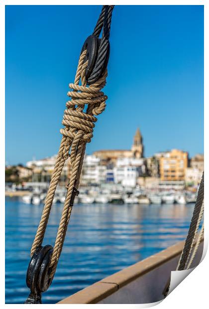 Small Spanish town in Costa Brava, Palamos.Foreground a sail boat rigging. Print by Arpad Radoczy