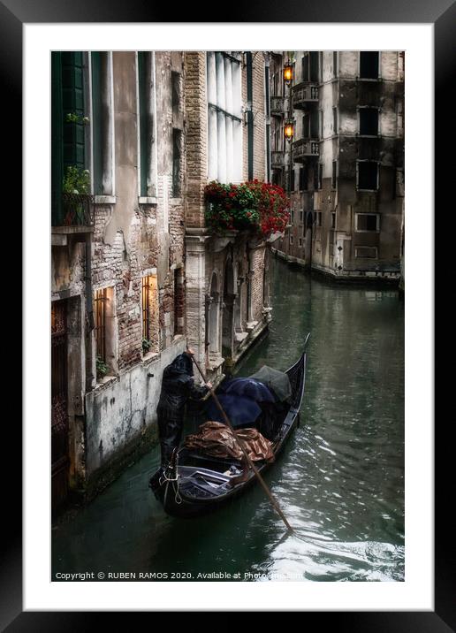 Man rowing a venetian gondola, Venice, Italy. Framed Mounted Print by RUBEN RAMOS