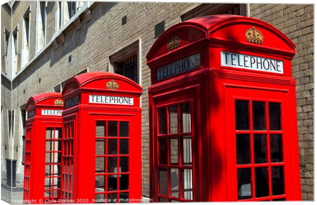 Red Telephone Boxes in London Canvas Print by Chris Dorney