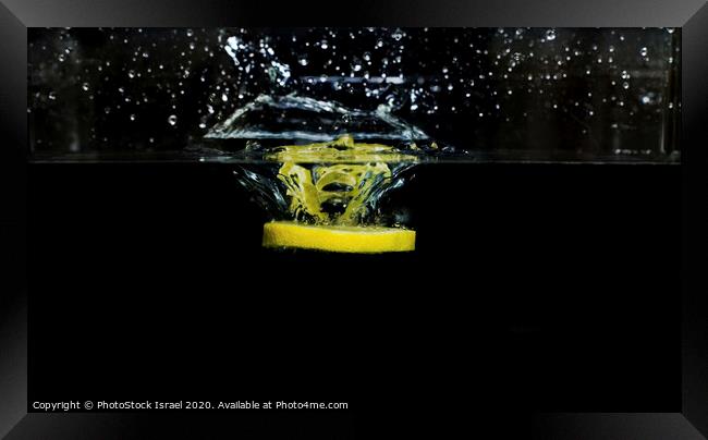 Lemon dropped into water  Framed Print by PhotoStock Israel