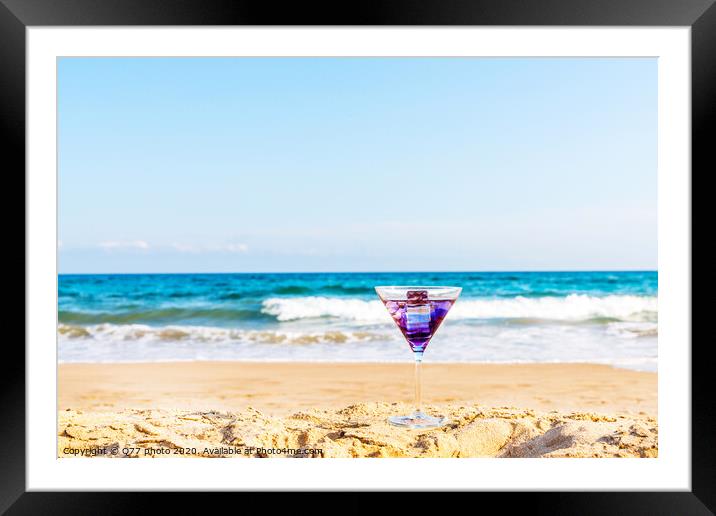drink in a martini glass on the background of the waves affecting the sandy beach, relax on the beach, refreshing drink during the holidays Framed Mounted Print by Q77 photo