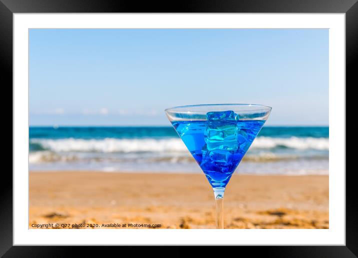 drink in a martini glass on the background of the waves affecting the sandy beach, relax on the beach, refreshing drink during the holidays Framed Mounted Print by Q77 photo