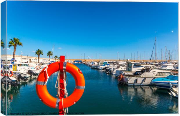 Beautiful luxury yachts and motor boats anchored in the harbor, hot summer day and blue water in the marina, blue sky Canvas Print by Q77 photo