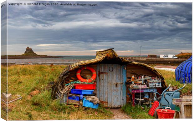 Upturned boats used as fishing shelters - on Holy Island. Canvas Print by Richard Morgan