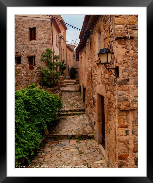 Mediterranean cobbled medieval street - Tossa De Mar Framed Mounted Print by Miguel Herrera