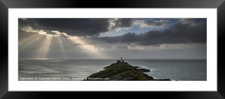 Landscape panorama of Mumbles lighthouse in Wales with sunbeams over sea Framed Mounted Print by Matthew Gibson