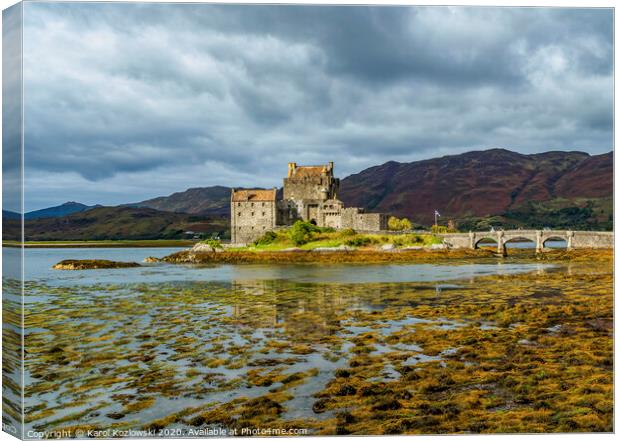 A body of water with Eilean Donan in the background Canvas Print by Karol Kozlowski