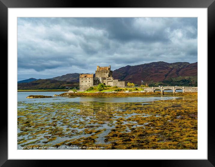 A body of water with Eilean Donan in the background Framed Mounted Print by Karol Kozlowski