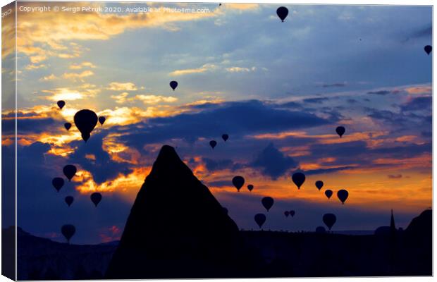 Attraction dozens of balloons climbed into the night sky above the conical peaks of the rocks in Cappadocia Canvas Print by Sergii Petruk