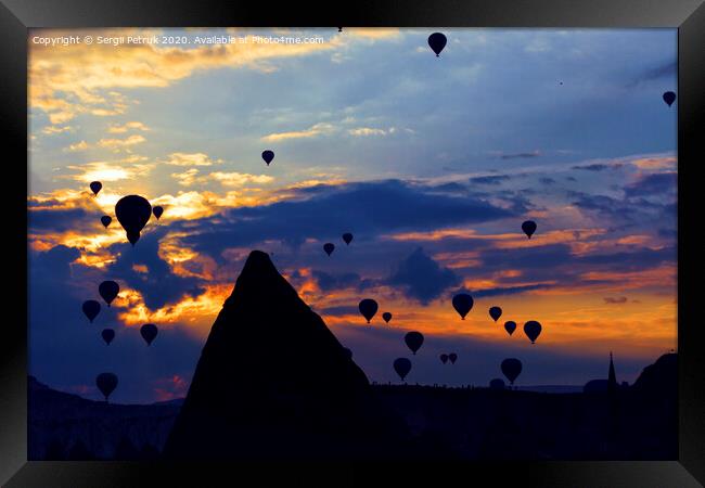 Attraction dozens of balloons climbed into the night sky above the conical peaks of the rocks in Cappadocia Framed Print by Sergii Petruk