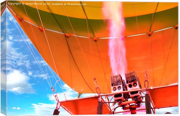 Fire of coral color comes out of a powerful gas torch and fills balloon balloon with hot air. Canvas Print by Sergii Petruk