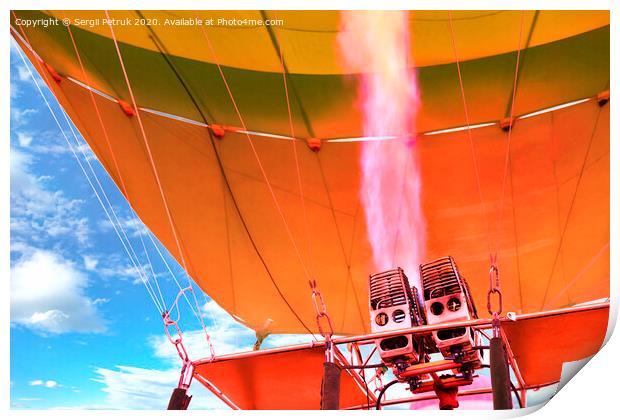 Fire of coral color comes out of a powerful gas torch and fills balloon balloon with hot air. Print by Sergii Petruk