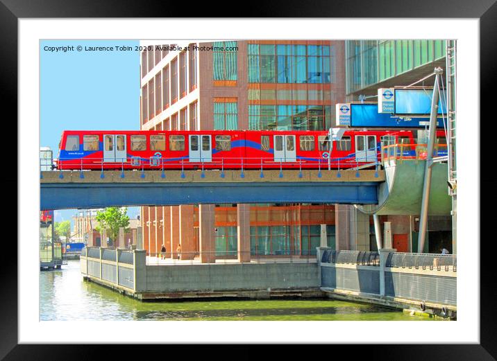 Docklands Light Railway train at Heron Quay Framed Mounted Print by Laurence Tobin