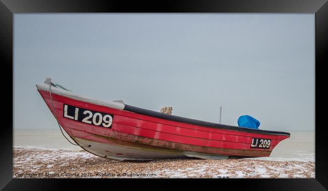 Red fishing boat in the snow Framed Print by Stuart C Clarke