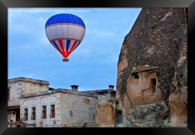 Balloon flying over the old town of Cappadocia Framed Print by Sergii Petruk