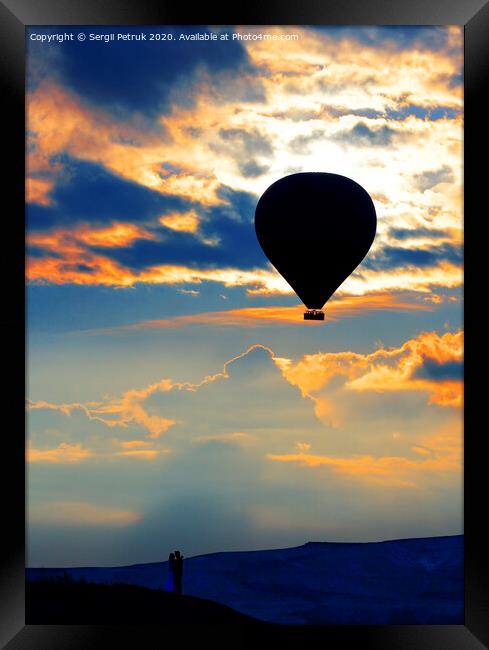 Silhouette of a loving couple and balloon against the morning sky with fiery red clouds Framed Print by Sergii Petruk