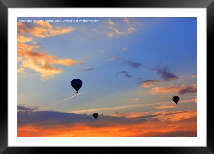 Silhouettes of balloons on the background of the morning sky with fiery red clouds. Framed Mounted Print by Sergii Petruk