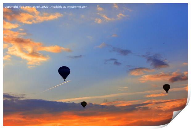 Silhouettes of balloons on the background of the morning sky with fiery red clouds. Print by Sergii Petruk