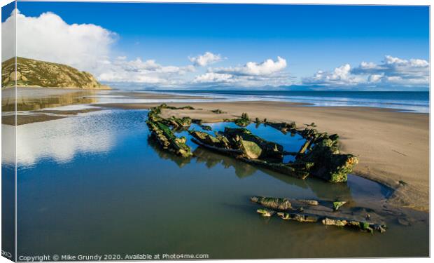 Low tide wreck Canvas Print by Mike Grundy