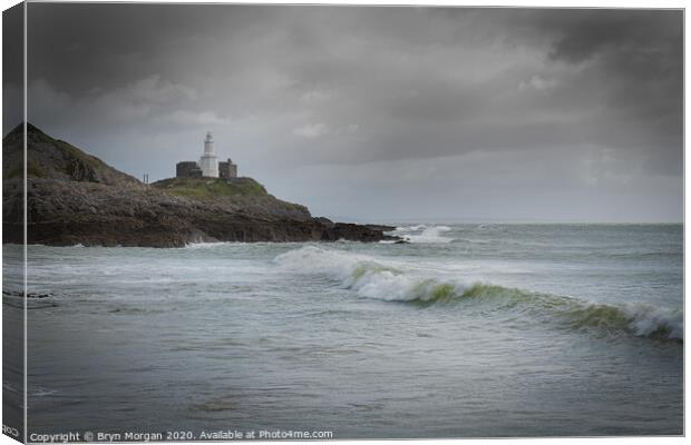 Mumbles lighthouse with wave. Canvas Print by Bryn Morgan