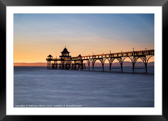 Beautiful long exposure sunset over ocean with pier silhouette Framed Mounted Print by Matthew Gibson