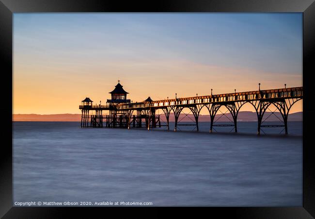 Beautiful long exposure sunset over ocean with pier silhouette Framed Print by Matthew Gibson