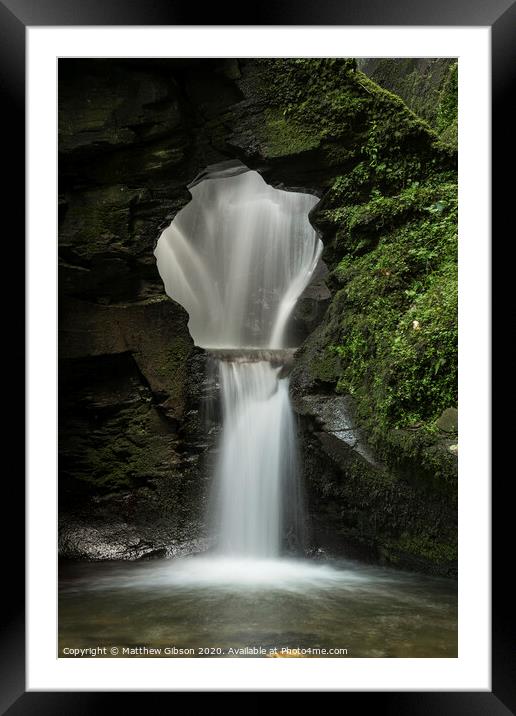 Beautiful flowing waterfall with magical fairytale feel in lush green forest location Framed Mounted Print by Matthew Gibson