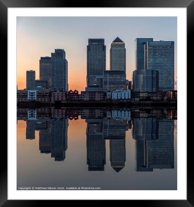 Cityscape landscape at sunset reflected in calm waters of lake Framed Mounted Print by Matthew Gibson