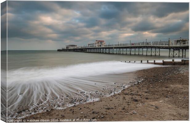Beautiful long exposure sunset landscape image of pier at sea in Worthing England Canvas Print by Matthew Gibson