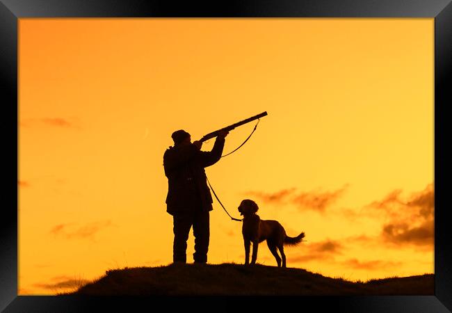 Hunter with Dog at Sunset Framed Print by Arterra 