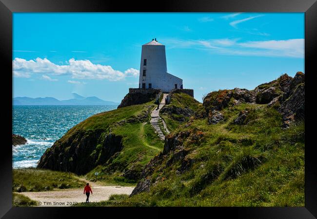 Walking towards Twr Mawr lighthouse on Llanddwyn Island Framed Print by Tim Snow