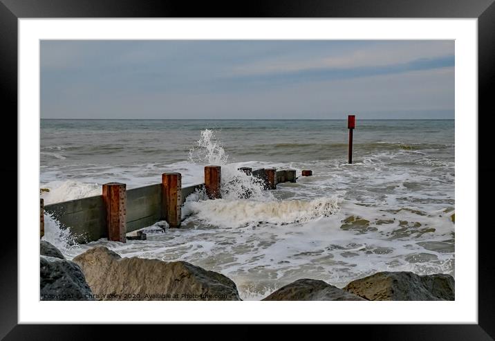 Waves crashing over the wooden groynes at high tide on Cart Gap beach Framed Mounted Print by Chris Yaxley