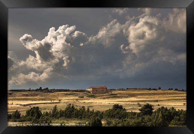 Stormy Clouds over a rural House  Framed Print by Pere Sanz