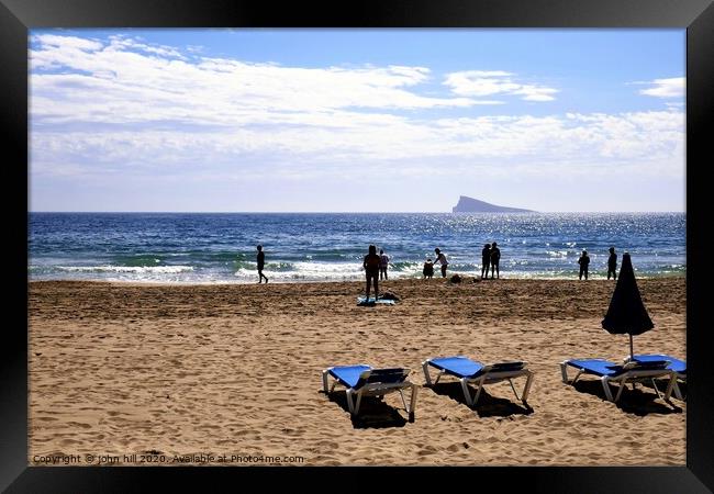 Silhouettes against the mediterranean at Benidorm in Spain. Framed Print by john hill