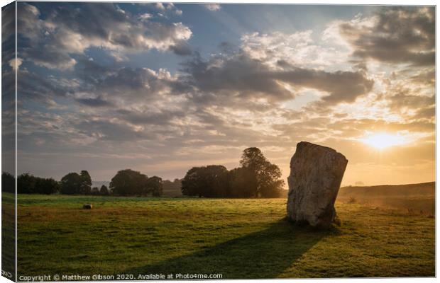 Stunning Summer sunrise landscape of Neolithic standing stones in English cluntryside with gorgeous light with slight background mist Canvas Print by Matthew Gibson