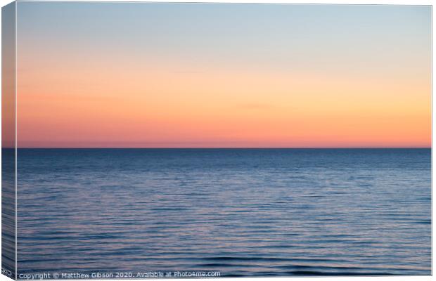 Beautiful Summer landscape sunset image of colorful vibrant sky over calm long exposure sea Canvas Print by Matthew Gibson