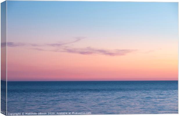 Beautiful Summer landscape sunset image of colorful vibrant sky over calm long exposure sea Canvas Print by Matthew Gibson