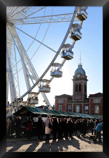 Ferris wheel silhouetted with the town hall at sunset. Framed Print by john hill