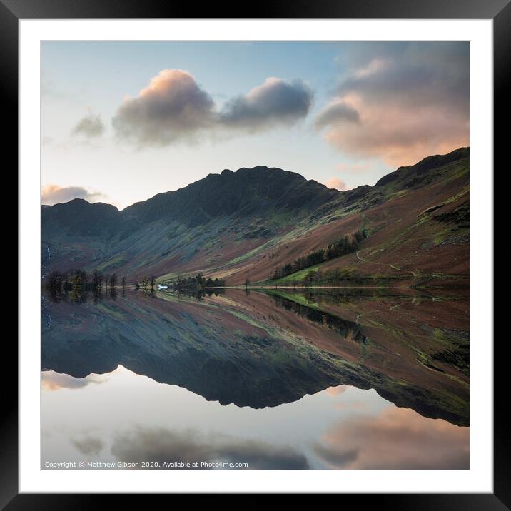 Majestic vibrant Autumn Fall landscape Buttermere in Lake District with beautiful early morning sunlight playing across the hills and mountains Framed Mounted Print by Matthew Gibson