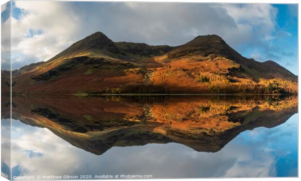 Majestic vibrant Autumn Fall landscape Buttermere in Lake District with beautiful early morning sunlight playing across the hills and mountains Canvas Print by Matthew Gibson